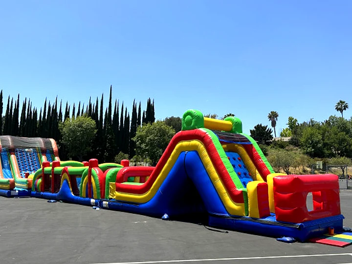 A long inflatable obstacle course set up outdoors